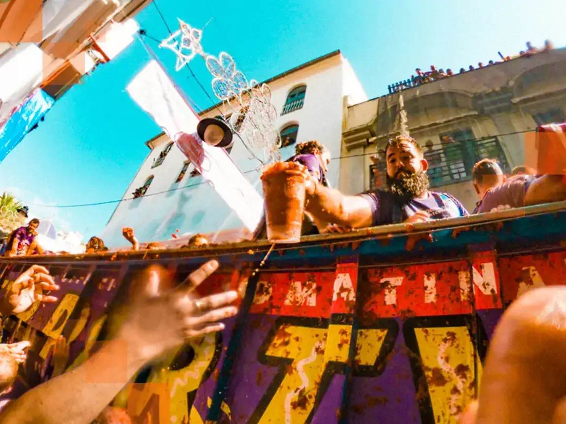 La Tomatina starts with lorries full of tomatoes driving into the city and handing out tomatoes or even dumping whole lorry loads on the streets for the revellers. © Miles Holder