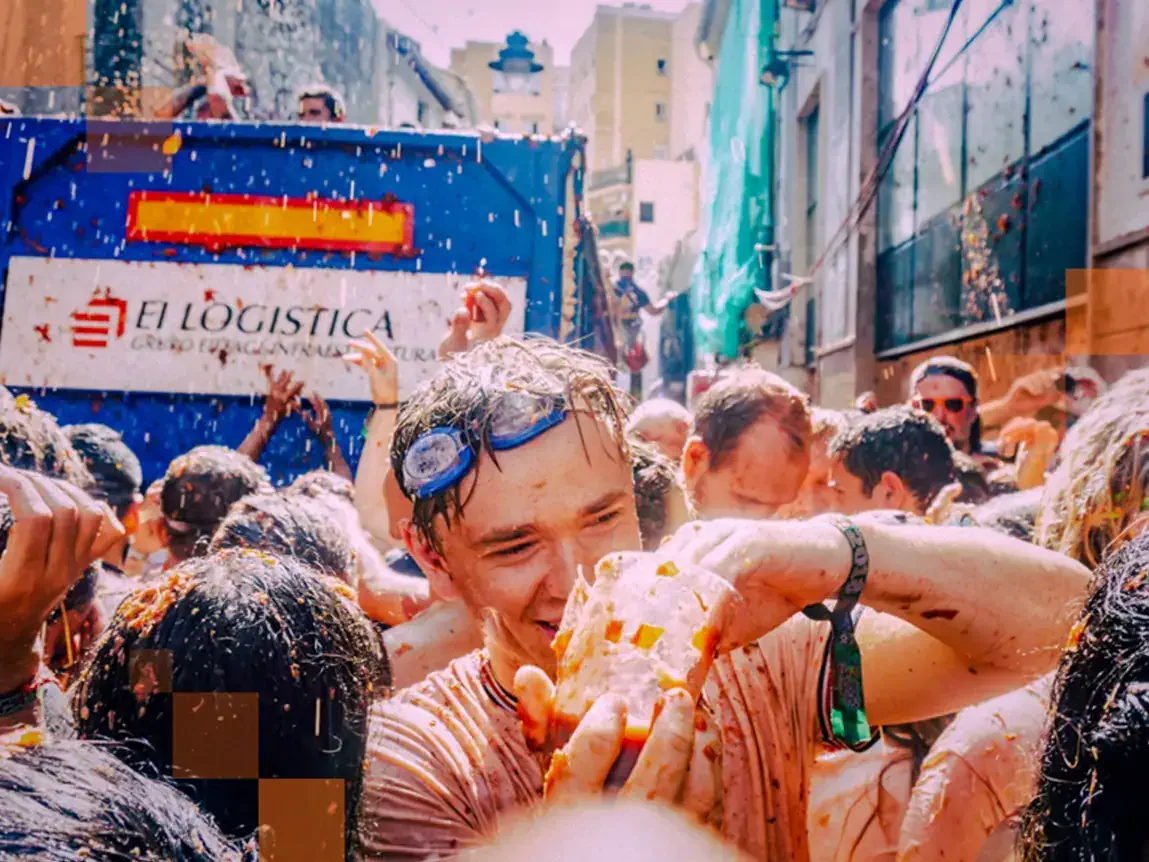 Armed with tomatoes as ammunition, revellers proceed to make a mess. © Miles Holder