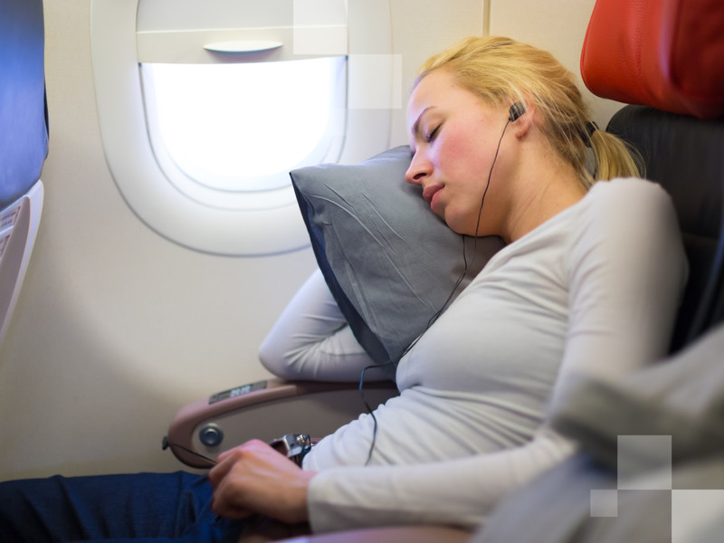 A comfortable pillow might be key to enjoy a few hours of sleep during your flight.