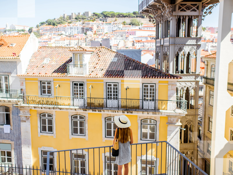 Woman admires beautiful hilly Lisbon